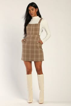 You'll be reaching for the Lulus Plaid to Be Yours Beige and Brown Plaid Pinafore Mini Dress all season long like it was made just for you! Brushed, wool-inspired woven fabric, with a brown and ivory plaid atop a beige background, shapes this cute pinafore dress that has a square neckline, an apron-style bodice, and wide straps that secure with hidden buttons at the back. A banded waist tops an A-line mini skirt with diagonal front pockets. Hidden zipper/clasp at back. Fit: This garment fits tru Plaid Dress Outfit, Winter Club Outfits, Plaid Overall Dress, Club Outfits For Women, Fall Dress Outfit, Lulu Fashion, A Line Mini Skirt, Pinafore Dress, Thanksgiving Outfit