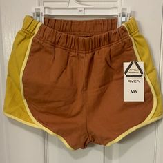 Funky 70s Style High Waisted Shorts From Rcva Retro Cotton Shorts With Elastic Waistband, Sporty Yellow High-waisted Shorts, Retro Summer Shorts, Retro Orange Summer Shorts, Orange Retro Summer Shorts, Sporty Brown Shorts For Spring, Retro Short Bottoms With Elastic Waistband, Mustard Cotton Shorts, Retro Bottoms With Elastic Waistband