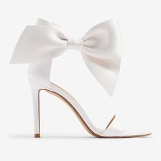 These Gorgeous Bridal Heels With A Classic Ankle Bow Detail Are The Perfect Statement Piece To Add To Your Look. Great For Your Wedding Or Other Special Occasions, These Will Have You Looking And Feeling Confident And Stylish. Features & Fabric Round Toe Sandals Strap Across The Toes Adjustable Ankle Closure; Bow Detail 4" Heel Padded Footbed Fabric/Metal Imported White Bow Heels, Sandals Strap, Fancy Event, Bridal Heels, Bow Heels, Feeling Confident, White Heels, White Bow, Toe Sandals