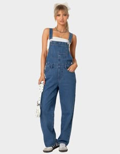 The Denim Craze Continues With These Overalls. These Overalls Are Effortlessly Casual With A Relaxed Fit For That Cool Girl Feel. Overalls. Straight Leg Fit. Button Detailing. Pockets. Belt Loops. 100% Cotton. Model Wears Size S. Model Height Is 5'6. Item Care: Machine Wash At Maximum Of 30ºc, Do Not Bleach, Tumble Dry Low, Iron At A Maximum Of 110ºc, Do Not Dry Clean. | Edikted Rosemary Denim Overalls Overalls And Tube Top, Overall Outfits, Flannel Sweatshirt, Wwe T Shirts, Blue Overalls, Style Overalls, Luke 2, Girls Overalls, Girls Graphic Tee