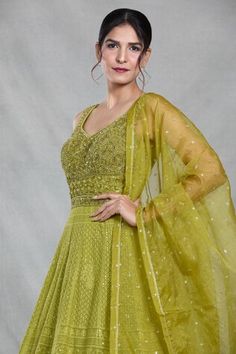 Green sleeveless full length gown with Mughal bloom embroidery using thread, sequin, beads and cutdana highlights. Paired with a ditsy sequin floret work dupatta. - Aza Fashions Anarkali Gown With Resham Embroidery, Sleeveless, Anarkali Gown With Resham Embroidery, Sleeveless Anarkali Gown With Resham Embroidery, Sleeveless Resham Embroidery Gown For Eid, Embellished Sleeveless Anarkali Set For Eid, Bollywood Style Sleeveless Dress For Reception, Sleeveless Bollywood Dresses For Receptions, Sleeveless Zari Work Gown For Eid, Festive Sleeveless Gown With Dupatta