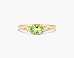 14K Yellow Gold Oval Peridot and Diamond Accent Birthstone Ring. The birthstone of August, peridot is known for its distinctive light green color and is said to bring strength, joy, prosperity, and good health to those who wear it. It is also known to bring harmony to romantic relationships and protect against evil, jealousy and even bad dreams. This delicate east-west peridot ring with accent diamonds is the perfect piece for your special someone Simpel Peridot Rings, Ruby And Peridot Rings, Peridot Engagement Rings Diamond, Peridot Engagement Rings, Buying Gold, Jewelry Photoshoot, Celebrity Engagement Rings, Ring Trends, Wedding Rings Solitaire