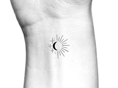 a black and white photo of a wrist tattoo