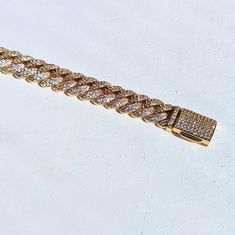 Get ready to sparkle with our Gold Diamond Cuban Link Bracelet dipped in real 18k gold. The perfect gift for a special someone, or simply treat yourself to some bling! An elegant, unique piece that many women would love to add to their collection. ✔Hypoallergenic ✔Water Resistant ✔Quality Guaranteed ✔Handmade Size: 7 inches length, 10mm width Material: 18k gold plated Gold Iced Out Diamond Bracelet For Formal Occasions, Gold Iced Out Bracelets For Formal Occasions, Elegant Iced Out Bracelet For Gift, Gold Cuban Link Jewelry For Party, Luxury Chain Tennis Bracelet As Gift, Luxury Chain Tennis Bracelet For Gift, Luxury Tennis Chain Bracelet As A Gift, Gold Cuban Link Party Jewelry, Dazzling Bling Bracelets For Gifts