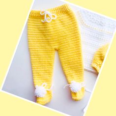 a baby's yellow and white knitted outfit with laces on the bottom