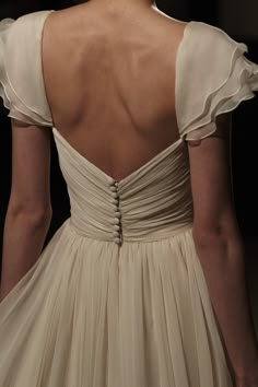 the back of a woman's dress with ruffles