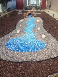 an outdoor play area with rocks and gravel