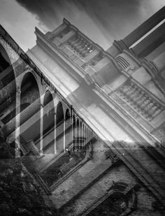 a black and white photo of an old bridge