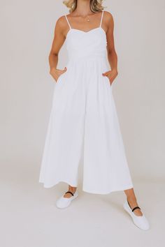 Introducing our Coconut Wrap Jumpsuit - the ultimate combination of comfort and style. With its wrap-around design and wide pant legs, this jumpsuit is perfect for any occasion. Embrace your playful side and stand out in this quirky and fun piece! Details Wrap-around Wide pant Pockets Lined to mid-thigh Spaghetti strap / tank top Sweetheart neckline Bow tie on back Sizing Approximate measurements: SIZE LENGTH/INSEAM BUST Small 53/30" 28" Medium 55/31" 32" Large 55/31" 34" Fabric has stretch in t