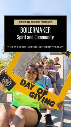 a woman holding up a sign that says boilermaker spirit and community with other people behind her