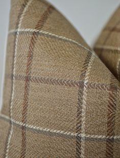 the back of a brown and tan plaid pillow