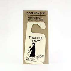 a white door hanger with an image of a man holding a bottle opener on it