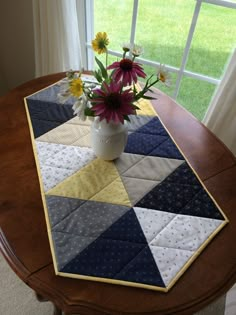 a vase with flowers sitting on top of a table