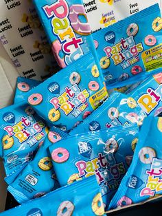 a pile of doughnuts sitting on top of a table next to other snacks