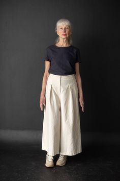 From Merchant & Mills comes a sewing pattern for a pair of culotte trousers featuring front pleats and an elasticated back waistband. Skill level: Intermediate. Sizes: UK 6-18 Fabric suggestions - Mid-weight cotton canvas, 8oz organic sanded twill, corduroy, light-medium weight wool and 7-10oz denim. Lighter weight cloth like Indian cotton, linen and Tencel/linen will give you a softer silhouette. Pattern is printed within Europe; the pattern paper is 70gsm white (FSC® certified) and made only 1 Merchant Mills, Merchant And Mills, Paper Sewing Patterns, Indie Sewing Patterns, Short Coat Jackets, Things To Sew, Clothes To Make, Blouse Pants, Patterned Sheets