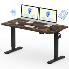 two computer screens sitting on top of a wooden desk next to each other with drawings above them