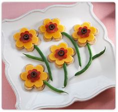 small cookies decorated with flowers on a plate