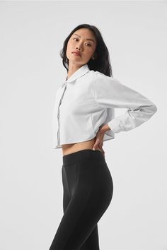 The Cropped Take Me Out Button Up is a year-round layer to wear on repeat. Made with a twill woven that’s lightweight yet warming along with hidden buttons for a sleek look, this cropped and collared long sleeve is the shacket, reimagined. Layer it over a bra top and leggings for an instant outfit that wears well anywhere. Classic Cropped Shirt For Daywear, Classic Spring Cropped Shirt With Button Cuffs, Classic Long Sleeve Cropped Shirt For Daywear, Alo Yoga Cotton Tops For Fall, Long Sleeve Cropped Shirt For Daywear, Classic Spring Cropped Shirt For Work, Classic Spring Cropped Work Shirt, Fitted Cropped Shirt With Button Cuffs For Work, Classic Spring Workwear Cropped Shirt