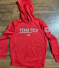 Under Armour * Texas Tech Red Raiders * Red * Men's * Medium * Hoodie. This hoodie is in MINT condition with NO tears or stains on the fabric Details:  1.) Size Medium  2.) Chest: 44" inches  3.) Waist: 42" in.  4.) Hip: 42" in.  5.) Shoulder to shoulder: 16" in.  6.) Shoulder to hem: 29" in.  7.) Sleeve length: 33" in.  8.) 100% Polyester  9.) Machine Wash  10.) Made in Vietnam  11.) Hood  12.) Front pockets  Thanks for looking & please look at my listings for more clothes Red Team Sweatshirt For Fall, Red Sweatshirt With Team Name For Fall, Red Team Name Sweatshirt For Fall, Red Team Spirit Hoodie For Fall, Red Winter Sweatshirt For Sports Events, Casual Red Sweatshirt For Fans, Red Team Name Sweatshirt For Sports Season, Red Hoodie For Fall Fan Gear, Red Hoodie With Letter Print For College