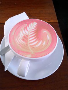 a cappuccino on a saucer with a spoon