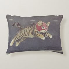 a pillow with a cat wearing a red mask on it's face and paws