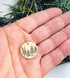 "Tree Necklace - Forest Necklace - Gift for Her - Stocking Stuffer - Winter Birthday Necklace - Pine Tree Necklace - Evergreen Jewelry 5/8\" brass disk is stamped with little pine trees, and given a rustic finish. It hangs from a dainty gold filled cable chain." Green Round Jewelry With Birth Flower, Green Birth Flower Round Jewelry, Green Birth Flower Jewelry, Nature-inspired Round Necklace For Gift, Nature-inspired Round Necklace For Gifts, Nature-inspired Round Necklaces For Gifts, Green Engraved Jewelry As Gift, Personalized Green Necklaces For Gifts, Personalized Green Charm Necklace For Gift