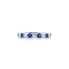 a white gold ring with blue sapphires and diamonds