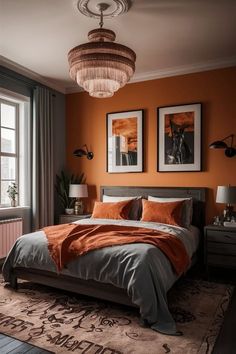 a bedroom with orange walls and gray bedding