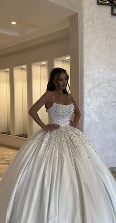 a woman in a white wedding dress posing for the camera