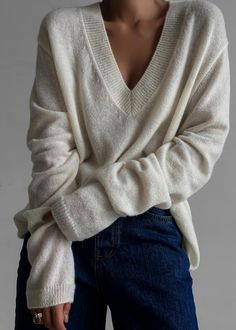 Color: Cream Lightweight wool blend fabric Regular fit Deep v neck Drop shoulders Rib knit trim Slip on style Unlined 35% Polyamide 30% Wool 25% Alpaca 10% Acrylic Dry Clean Imported