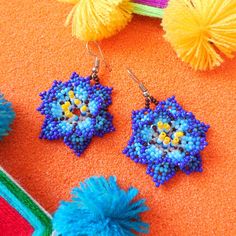 Embrace nature's bloom with our Huichol Beaded Flower Earrings🌺. Expertly handcrafted by one of our partner Huichol artisans, these earrings radiate with vibrant bead patterns, reflecting the beauty of blossoming flowers. They're a must-have for those looking to add a splash of color and cultural charm to their ensemble. Dive into the world of Huichol craftsmanship and let your style flourish！ ◆Symbols in Huichol Jewelry◆ Flowers: They are sacred and used in the healing process and Huichol cele Flower Shaped Beaded Earrings With Flower Charm, Flower-shaped Beaded Earrings With Flower Charm, Gift, Flower Shaped Beaded Earrings With Flower Charm For Gift, Flower Beaded Earrings With Flower Charm As Gift, Unique Flower Beaded Earrings Gift, Unique Flower Beaded Earrings For Gift, Blue Flower Beaded Earrings For Gift, Handmade Flower Beaded Earrings As Gift, Handmade Flower Shaped Beaded Earrings As Gift