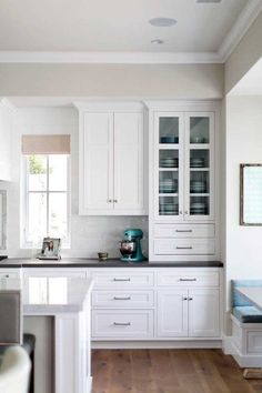 the kitchen is clean and ready for us to use it's white cabinetry