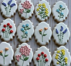 decorated cookies with flowers on them sitting on a table