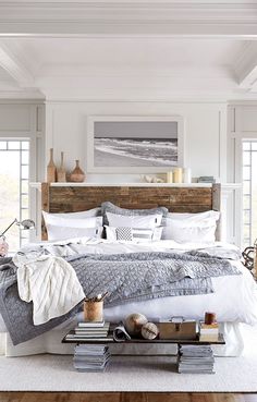 a large bed sitting in a bedroom next to a wooden headboard on top of a hard wood floor