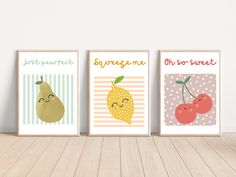 three framed posters with fruits on them in different colors and designs, one is for children's room