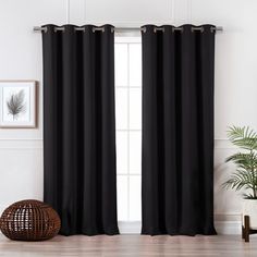 the black curtains in this room are ready to be hung