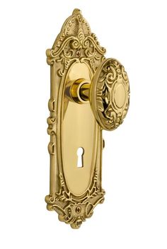 an ornate brass door handle with a keyhole on the front and side panel is shown