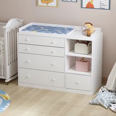 a baby's room with a crib and dresser