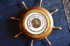 an old fashioned barometer sitting on top of a table