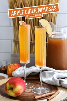 two glasses filled with apple cider mimosa sitting on top of a wooden tray