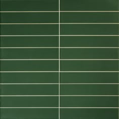 a green tile wall with horizontal lines on it