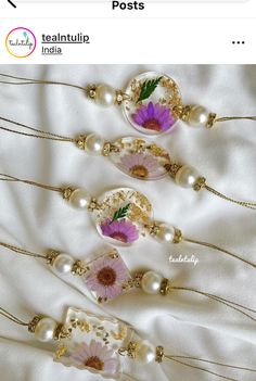 three necklaces with flowers and pearls on them