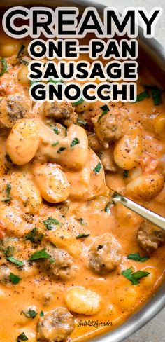 creamy one - pan sausage and gnocchi sauce in a skillet with a spoon