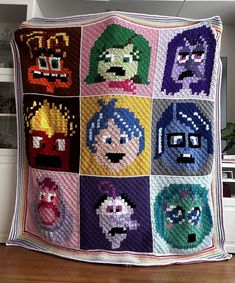 a crocheted blanket with cartoon characters on it