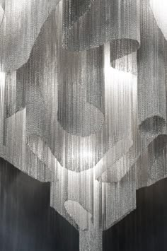 a chandelier hanging from the ceiling in front of a black and white background