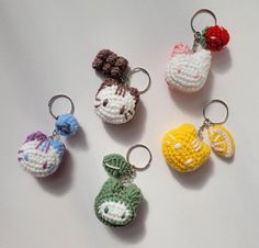 four crocheted keychains with different designs on them