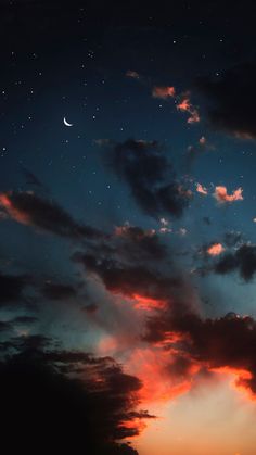 the sky is filled with clouds and stars as the sun sets in the distance behind it