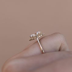 Details Metal 14K Gold Moissanite Center Stone Option 9x4.5mm Marquise Forever One Colorless Moissanite - Charles & Colvard Lab Diamond Center Stone Option 0.70 - 0.75 carat Marquise Diamond - G color, VS2 clarity - IGI certified Natural Diamond Center Stone Option 0.70 - 0.75 carat Marquise Diamond - H color, SI1 clarity - GIA certified Accent Stones Full Cut Round Brilliant Natural Diamonds & Marquise Natural Diamond, SI1 Clarity, G-H Color, 0.16 total carat weight Customization Want to change Marquise Cut Moissanite Halo Ring For Anniversary, Anniversary Moissanite Halo Ring Marquise Cut, Anniversary Moissanite Marquise Cut Halo Ring, Halo Setting Marquise Cut Wedding Ring, Marquise Cut Diamond Wedding Ring With Halo Setting, Timeless Rose Cut Diamond Halo Ring For Wedding, Wedding Halo Ring With Rose Cut Diamonds, Marquise Cut Cubic Zirconia Wedding Ring With Halo Design, Moissanite Rings With Halo Setting And Marquise Cut