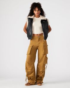 Expertly designed for a structured and voluminous fit, the DUO pant is crafted from midweight cotton twill fabric. With adjustable ankle straps, these wide leg cargo pants offer a versatile silhouette that can be easily customized to your preference. Mid rise cargo pants Zipper fly with shank button closure Two side pockets, two back patch pockets, and five cargo pockets down the legs Bottom 3 cargo pockets feature extended zipper pulls Snap strap at hem to cinch ankles Inseam: 31" 100% cotton H Wide Leg Cargo Pants, Cargo Pants Outfit, Shank Button, Spring Tops, Spring Looks, Sweaters Knitwear, Twill Fabric, Bottom Clothes, Ankle Straps