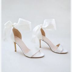 Never Worn Beautiful Ivory Heel. Satin Bow Ties Around Ankle. Company Wouldn’t Return Because It Was Past Return Date. White Open Heel Heels With Bow, White Heels With Bow And Open Heel, White Feminine Heels With Padded Heel, Feminine White Heels With Padded Heel, White Low Heel Feminine Shoes, Cream Open Toe Heels With Bow, Feminine Cream Open Toe Wedding Shoes, Feminine White Ankle Strap Heels, Chic White Wedding Shoes With Bow